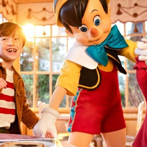 Au Chalet de la Marionnette Pinocchio Hand in Hand mit einem Mädchen und einem Jungen